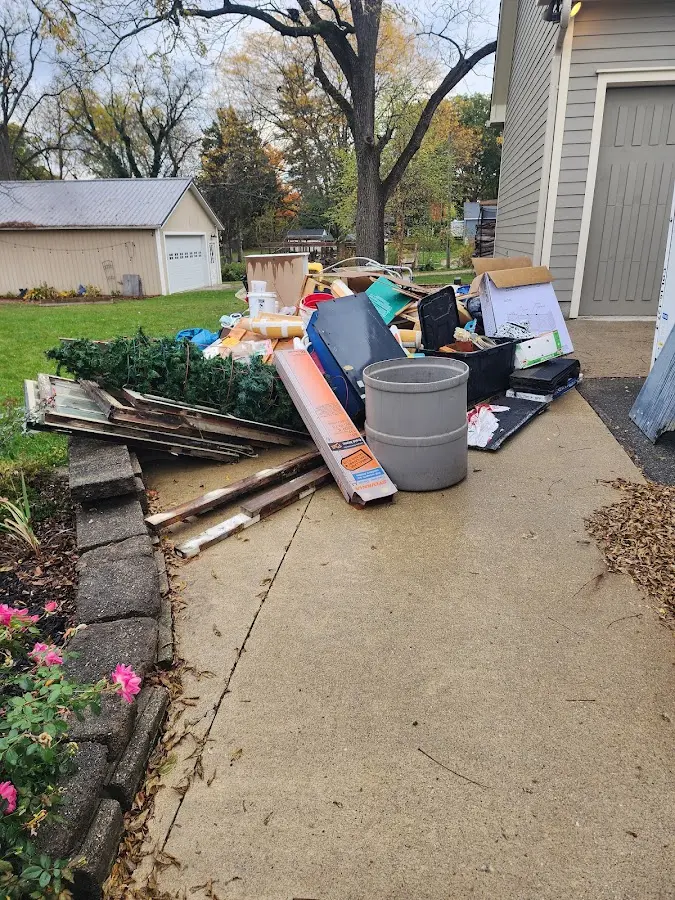 Dumpster being loaded with debris for 12 Yard Dumpster Rental in Tipp City